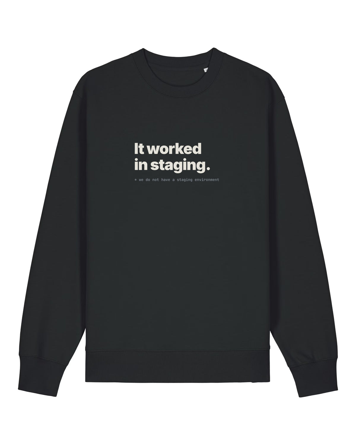 Black crewneck sweatshirt with "It worked in staging." with a footnote about having no staging environment