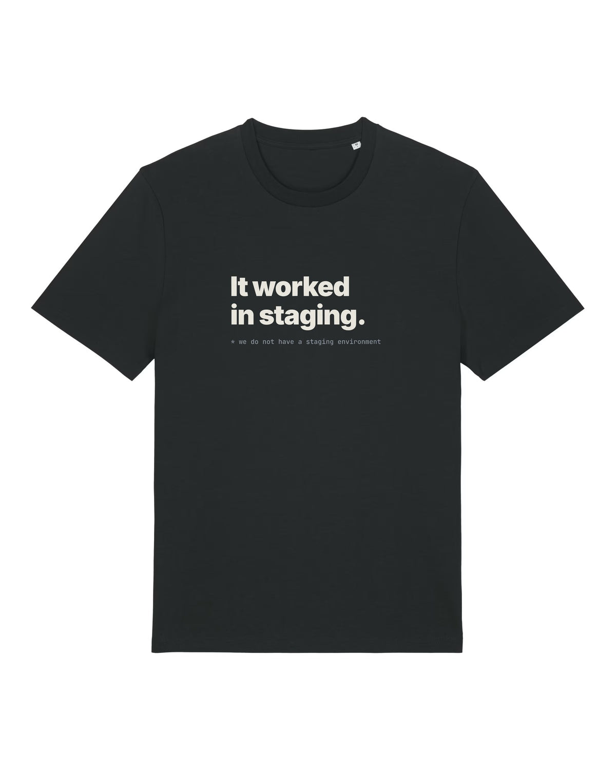Black t-shirt with "It worked in staging." with a footnote about having no staging environment
